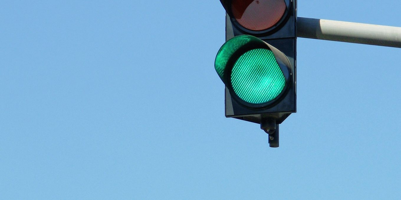 A traffic light against a blue sky